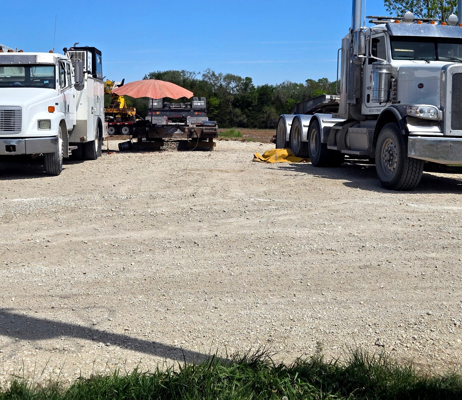 Service truck and heavy equipment on job site