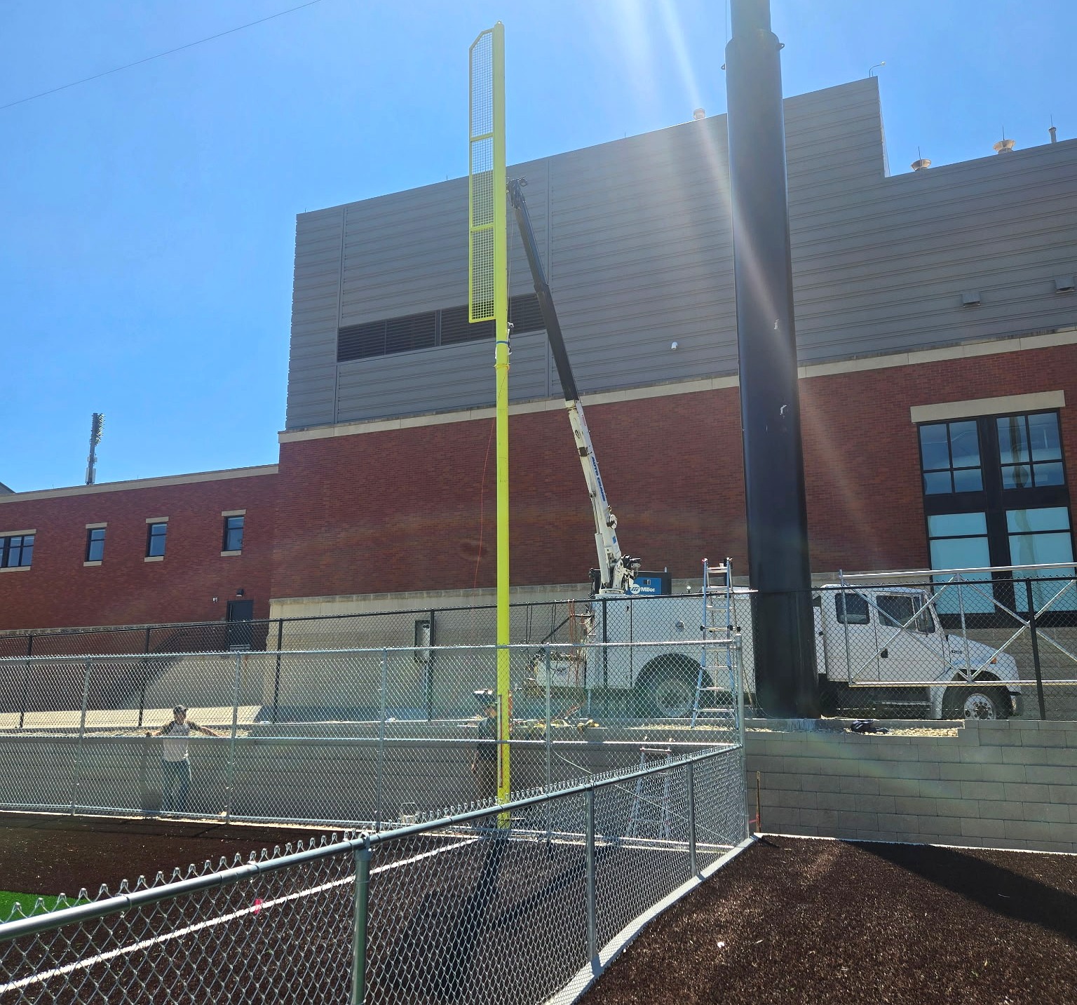 Stadium foul pole installation with service truck crane